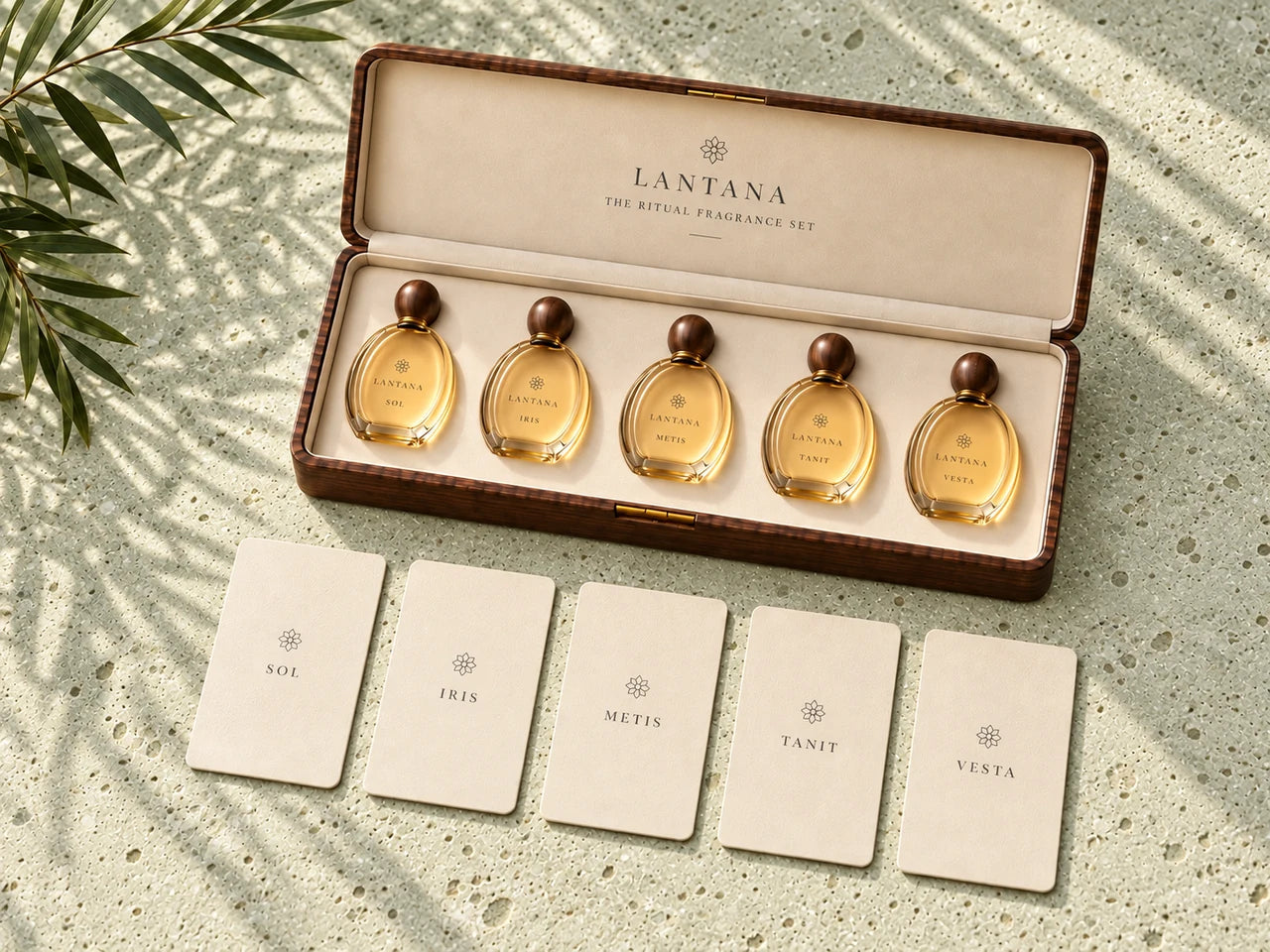The open wooden Lantana case with five oval perfume bottles and five ivory ritual cards arranged on warm limestone.