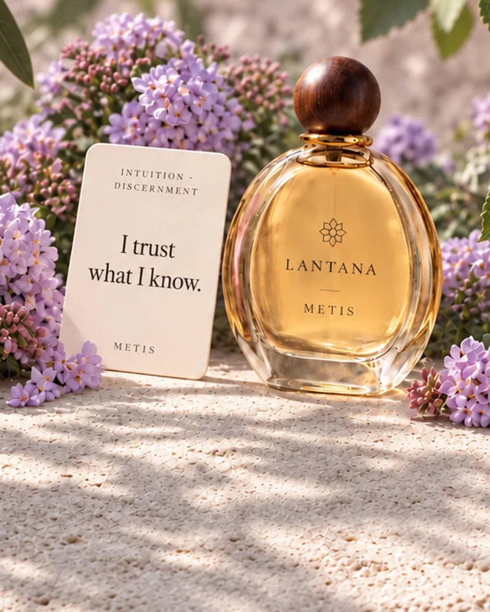 METIS perfume bottle and its Intuition and Discernment intention card with lavender lantana and figs in a cool, shaded Mediterranean garden.