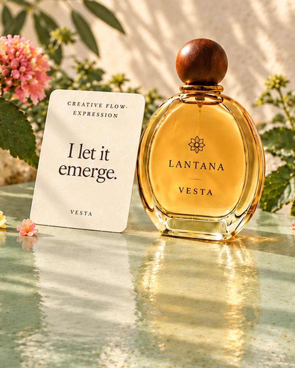 VESTA perfume bottle and its Creative Flow and Expression intention card with pastel lantana reflected in pale sage glazed ceramic.
